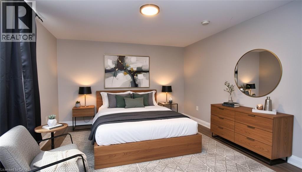 Spacious room featuring neutral wall tones, recessed lighting, and wood-finish flooring - 242 James Street S, Hamilton, ON