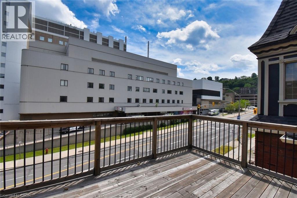 Outdoor deck featuring wood-finish flooring and a wood and metal railing system - 242 James Street S, Hamilton, ON