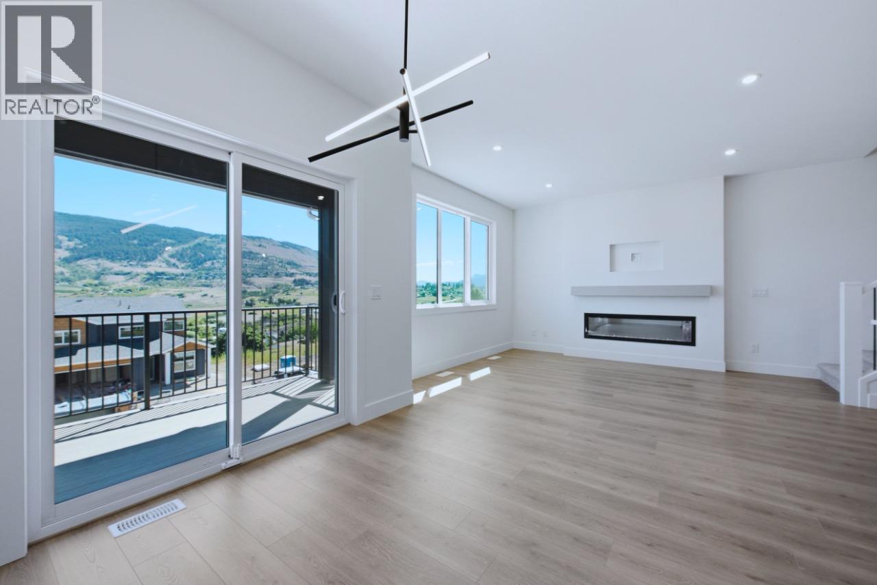 377 Arrowleaf Rise, Coldstream, BC - Indoor Photo Showing Living Room With Fireplace