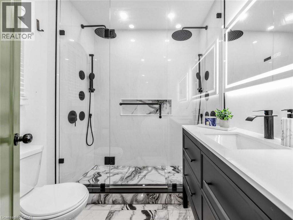 3 piece Ensuite bathroom- Walk-in shower with dual rain shower heads, matte black fixtures, and a recessed niche - 13 Swanhurst Boulevard, Mississauga, ON - Indoor Photo Showing Bathroom
