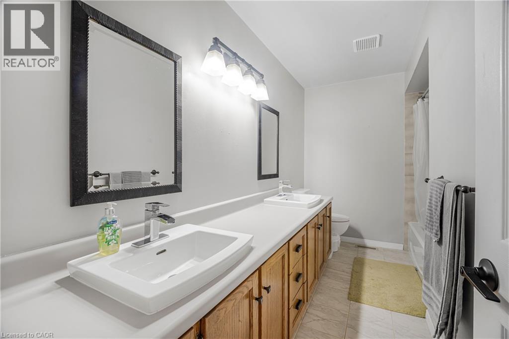 Bathroom featuring a dual vanity with rectangular vessel sinks and chrome fixtures - 23 Millpond Place, Mountain, ON