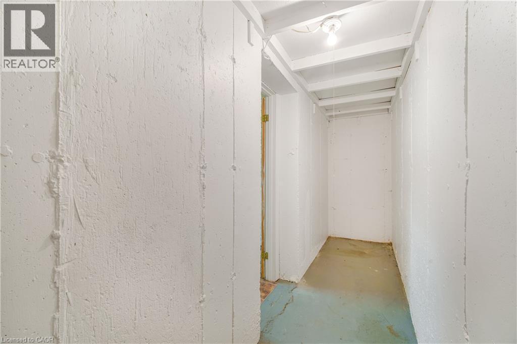 Utility space featuring exposed ceiling joists and a single ceiling-mounted light fixture - 23 Millpond Place, Mountain, ON