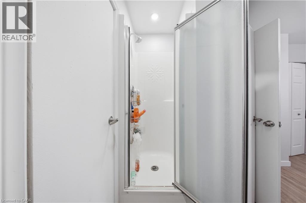 Walk-in shower with a frosted glass door and chrome trim - 91 Westmount Road Unit# 3, Waterloo, ON