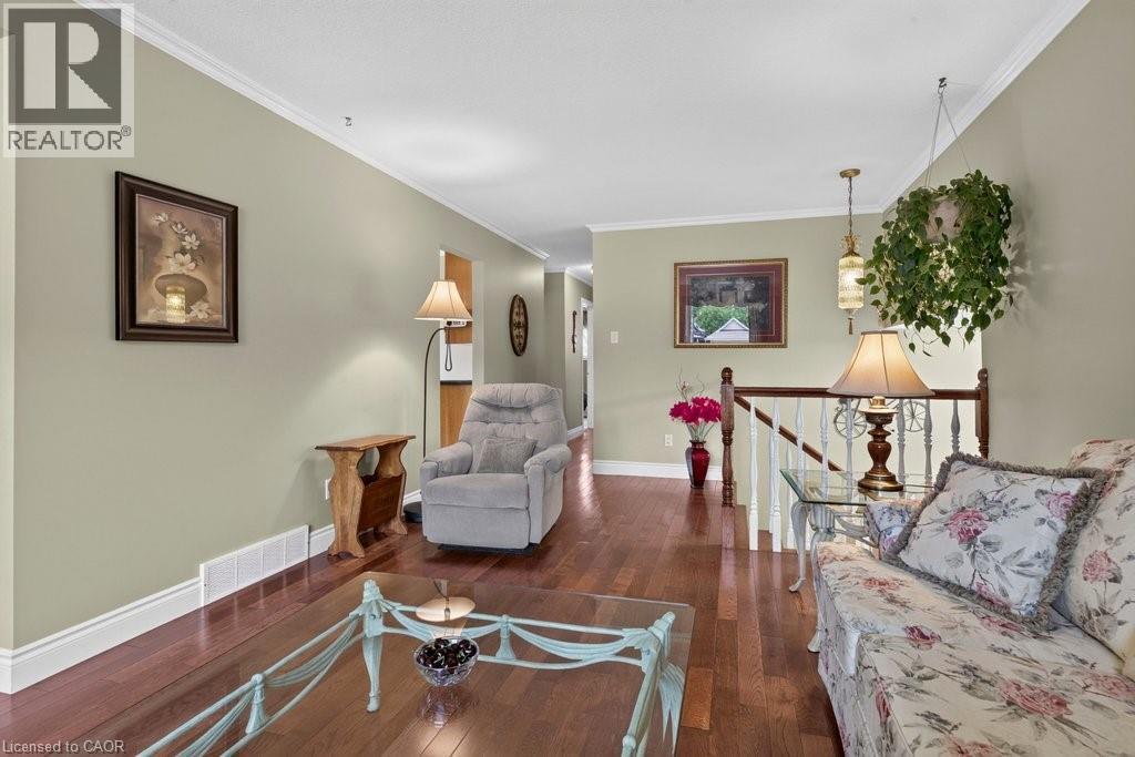 Hardwood-finish flooring extending throughout the living space - 409 Mohawk Road W, Hamilton, ON