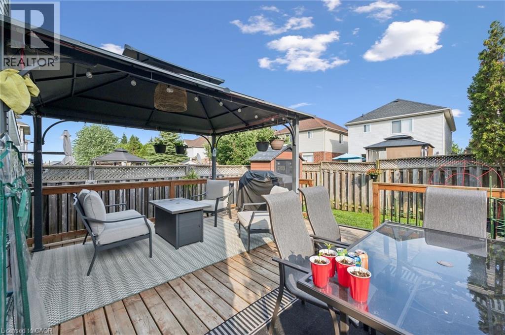 Expansive wood deck with a built-in gazebo featuring string lighting - 765 Angler Way, Waterloo, ON
