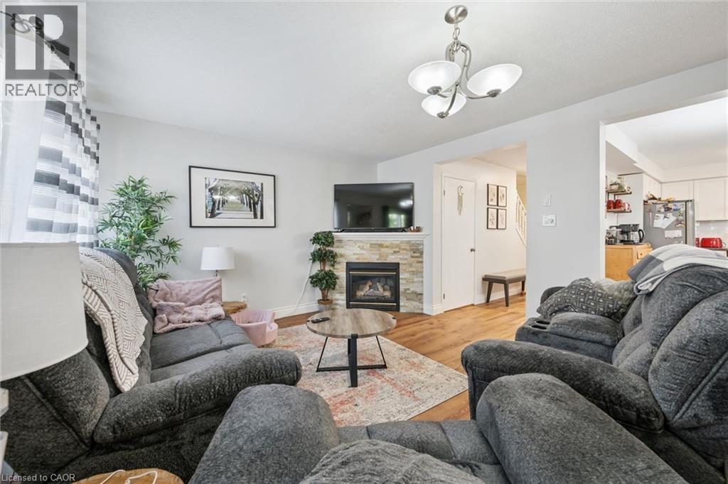 Living area with wood-finish flooring and light wall colors - 765 Angler Way, Waterloo, ON