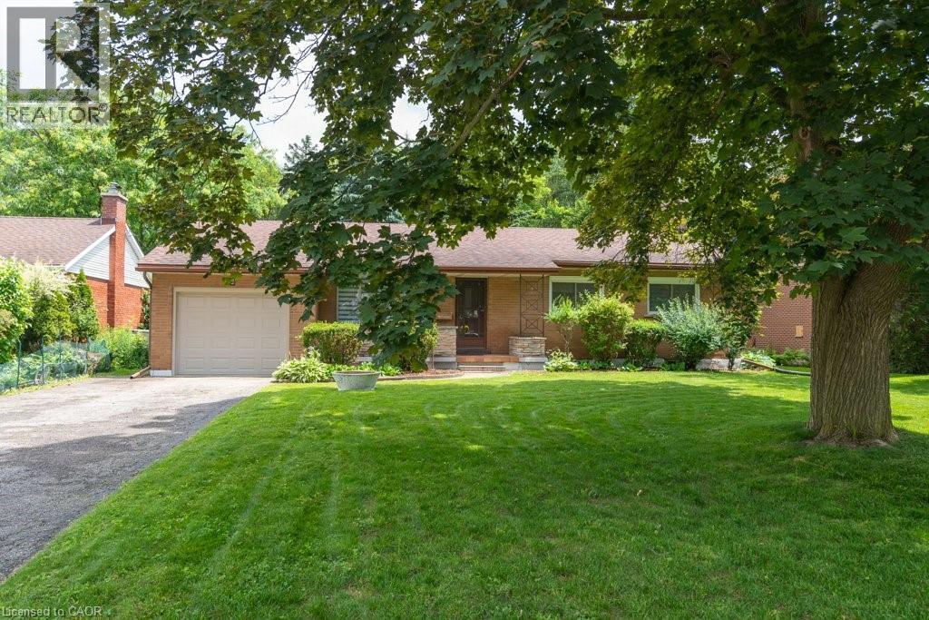 Brick exterior residence featuring a single-car garage and a paved driveway - 139 Mackay Crescent, Waterloo, ON