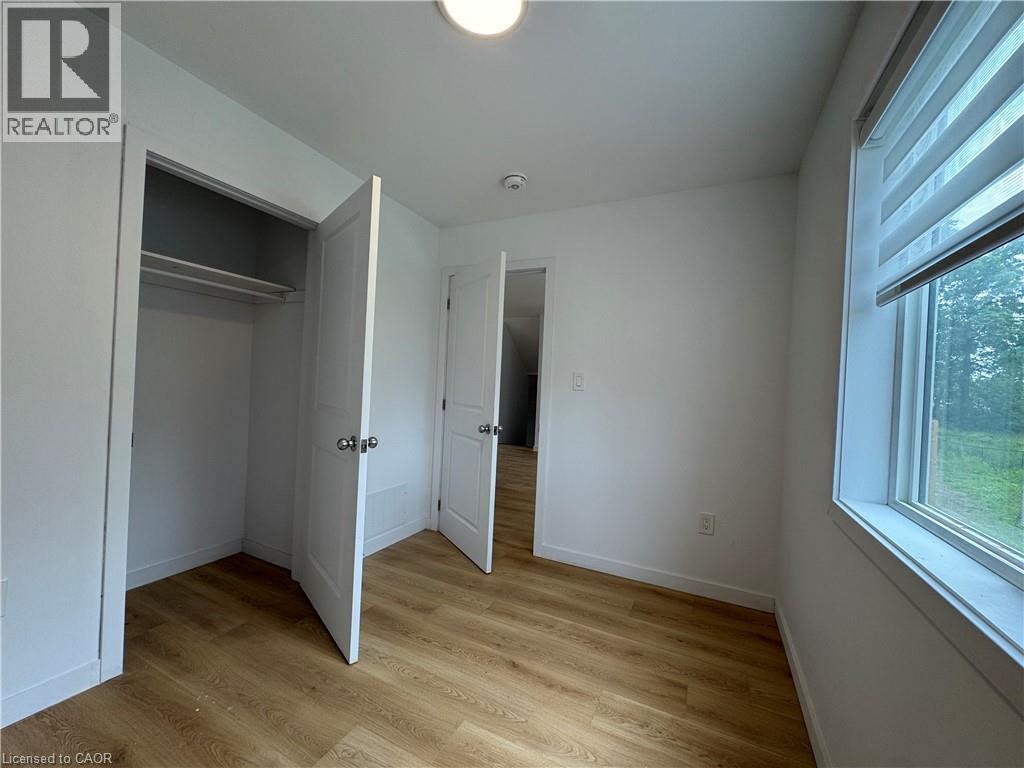 Room featuring wood-finish flooring, crisp white walls, and a recessed ceiling light - 113 Highriver Trail Unit# Main, Welland, ON - Indoor Photo Showing Other Room