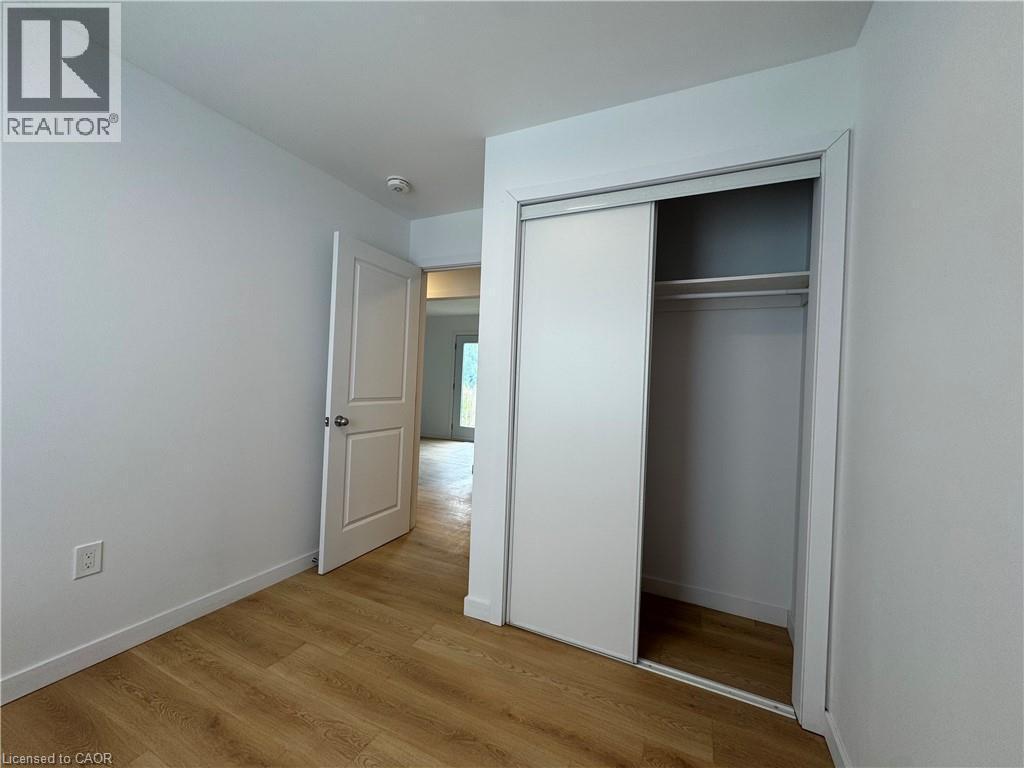 Room featuring wood-finish flooring, white walls, and a recessed ceiling light - 113 Highriver Trail Unit# Main, Welland, ON - Indoor Photo Showing Other Room