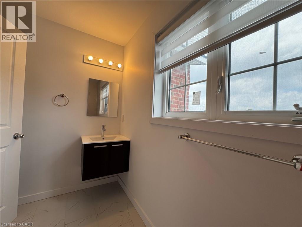 Floating vanity with white countertop, chrome faucet, and integrated sink - 119 Highriver Trail Unit# Main, Welland, ON - Indoor