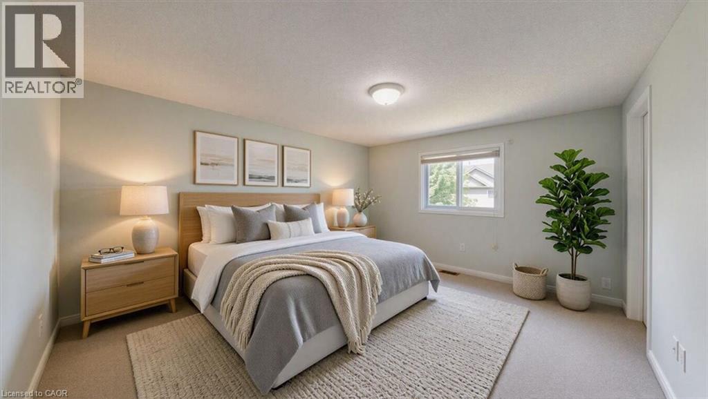 Bedroom featuring carpeting, light-toned wall paint, and a window with exterior views - Virtually staged - 980 Creekside Drive, Waterloo, ON - Indoor Photo Showing Bedroom