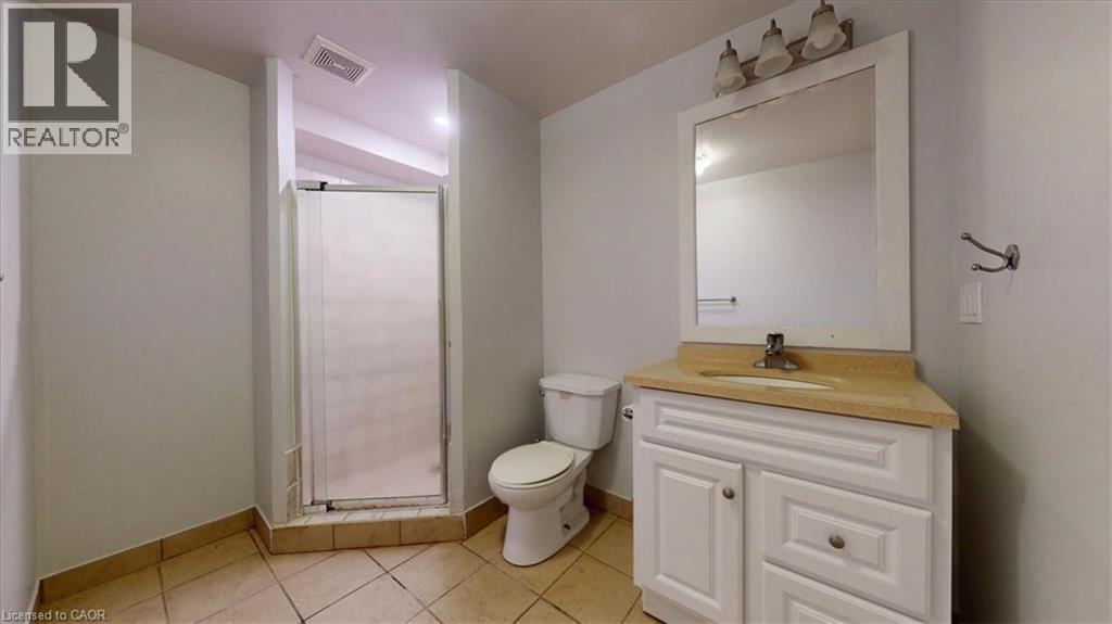 Bathroom featuring a corner vanity with a light-colored countertop and a framed mirror - 980 Creekside Drive, Waterloo, ON - Indoor Photo Showing Bathroom