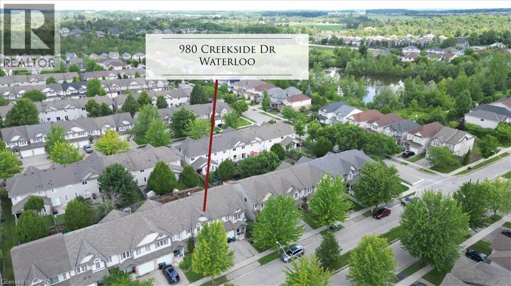 Aerial perspective of a residential neighborhood featuring rows of townhomes and detached properties - 980 Creekside Drive, Waterloo, ON - Outdoor With View