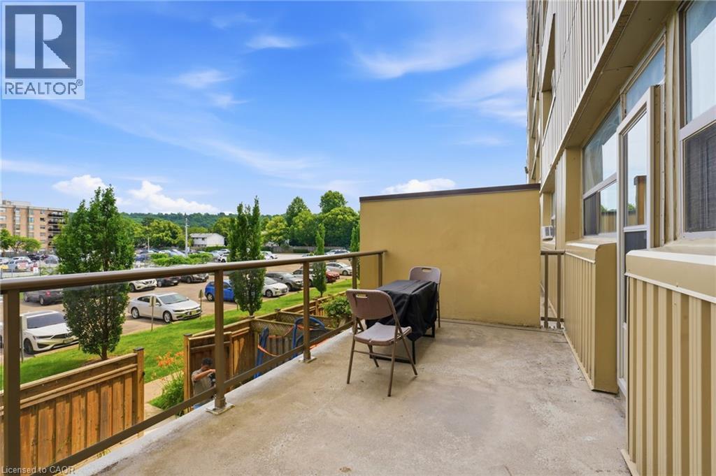 Concrete balcony with clear glass railing and metal frame, offering open-air space - 15 Nicklaus Drive Unit# 17, Hamilton, ON
