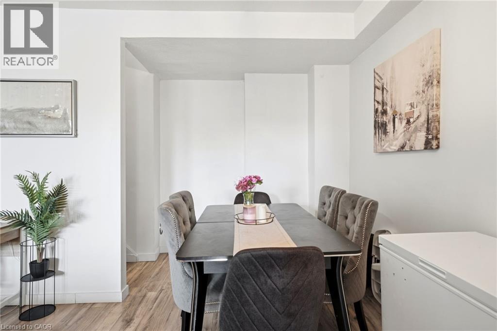 Dining area featuring light wood-finish flooring, white wall finishes, and a recessed ceiling - 15 Nicklaus Drive Unit# 17, Hamilton, ON