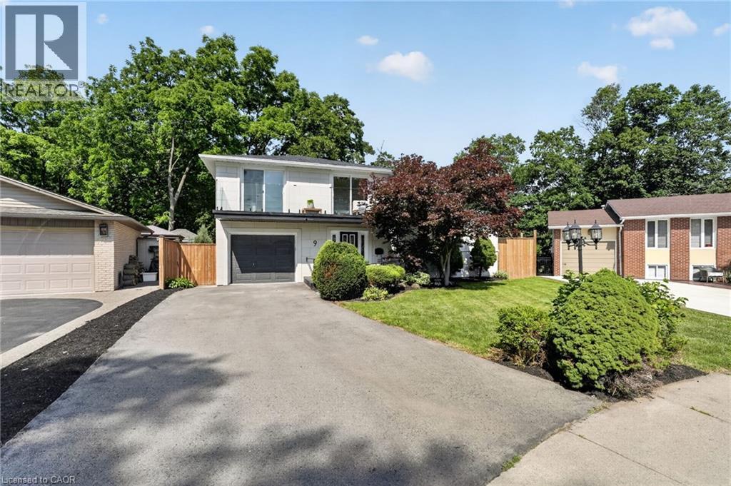 Contemporary-style residence featuring a white facade and a dark gray garage door - 9 Leslie Drive, Hamilton, ON - Outdoor