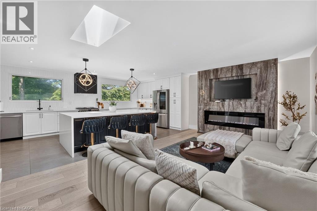 Open-concept living space with a contemporary kitchen and living area - 9 Leslie Drive, Hamilton, ON - Indoor Photo Showing Living Room With Fireplace