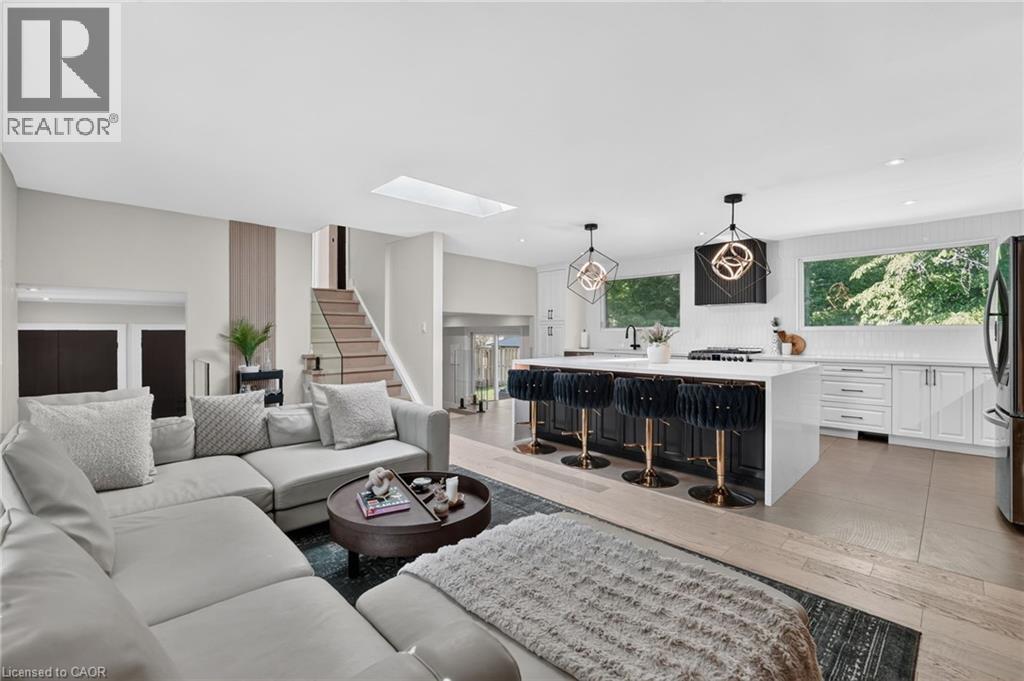 Open-concept living area with light wood-finish flooring - 9 Leslie Drive, Hamilton, ON - Indoor Photo Showing Living Room