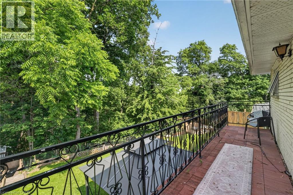 Balcony featuring patterned wrought iron railing and terracotta-toned floor tiles - 9 Leslie Drive, Hamilton, ON - Outdoor With Exterior