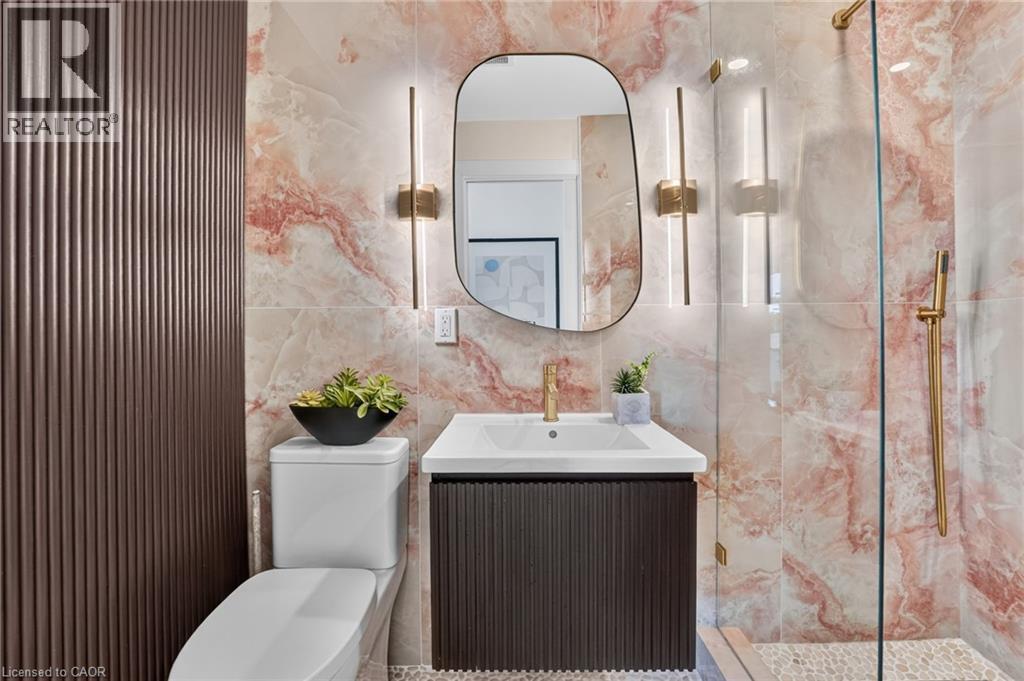 Contemporary bathroom featuring large format pink marble-look wall tiles - 9 Leslie Drive, Hamilton, ON - Indoor Photo Showing Bathroom