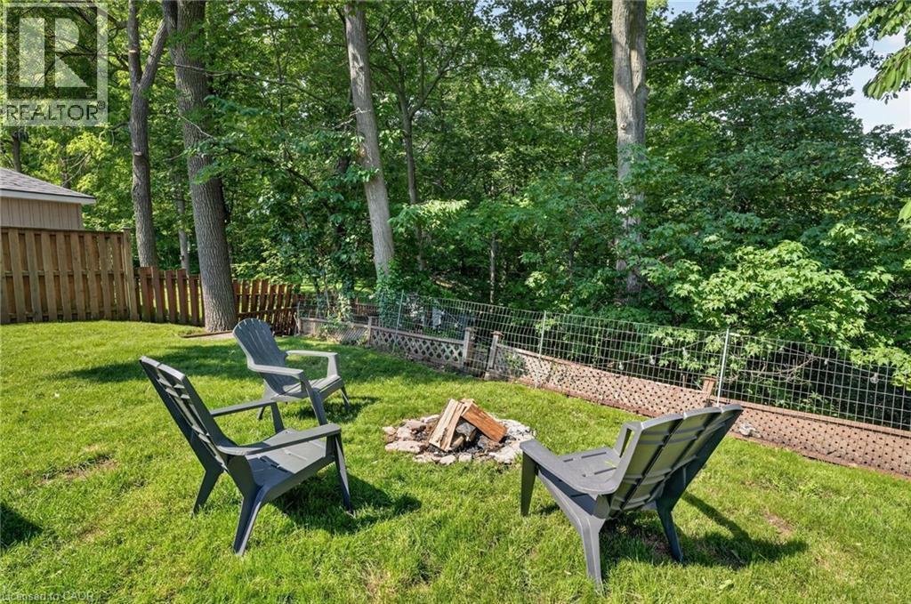 Expansive green lawn featuring a built-in fire pit - 9 Leslie Drive, Hamilton, ON - Outdoor