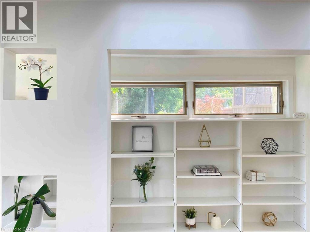 Built-in shelving unit featuring multiple open shelves, integrated window, and recessed wall niches - 919 Montgomery Drive, Ancaster, ON