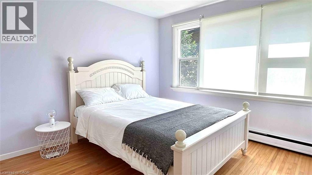 Hardwood flooring throughout featuring light purple walls and white trim - 919 Montgomery Drive, Ancaster, ON