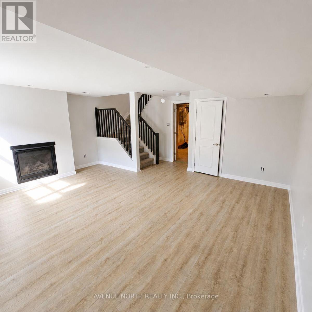 Recroom after new floor installed. - 323 Lysander Place, Ottawa, ON - Indoor With Fireplace
