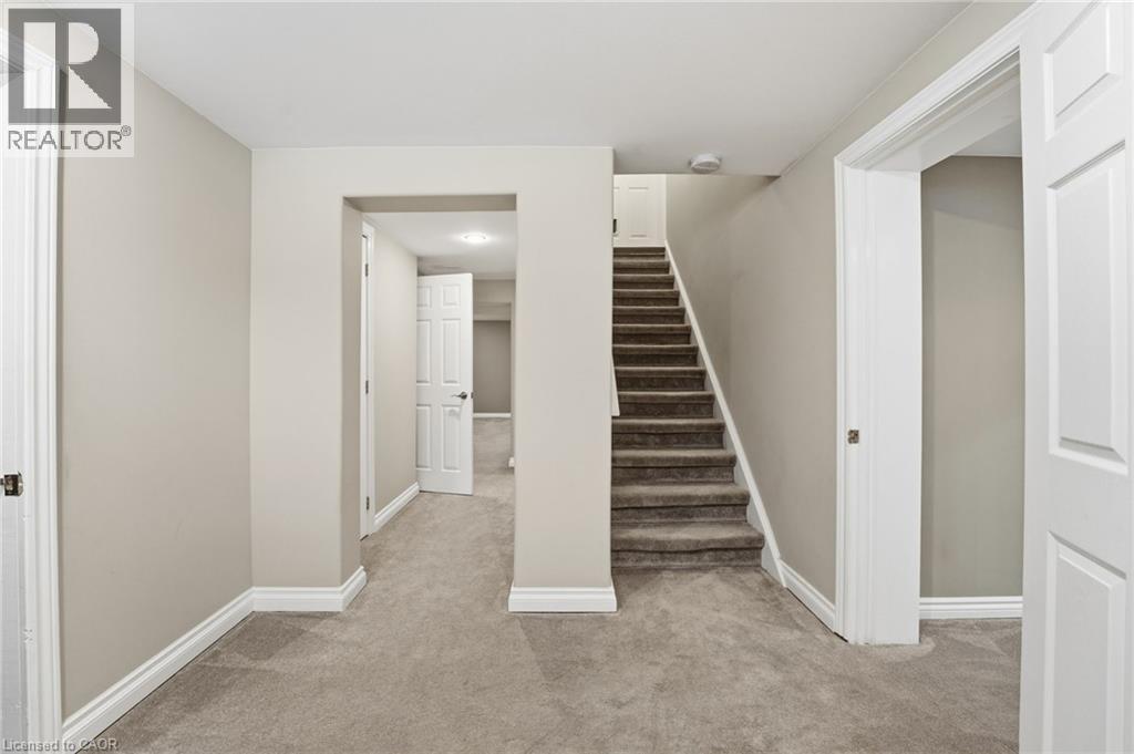Stairway with carpet flooring and baseboards - 473 Mohawk Road W, Hamilton, ON