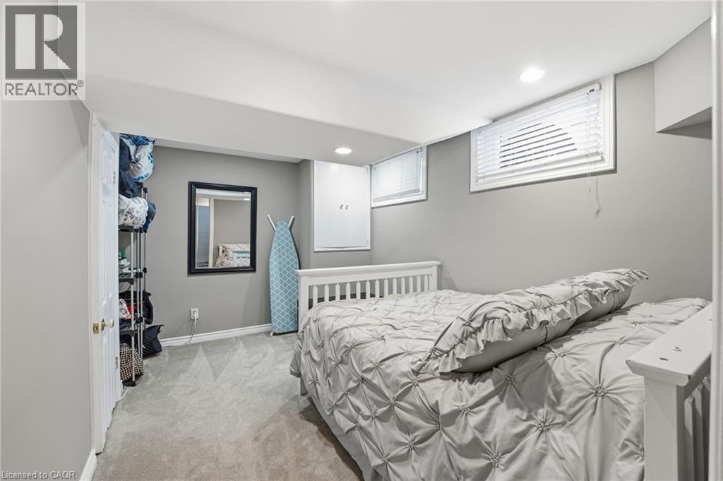Bedroom with light carpet and recessed lighting - 473 Mohawk Road W, Hamilton, ON