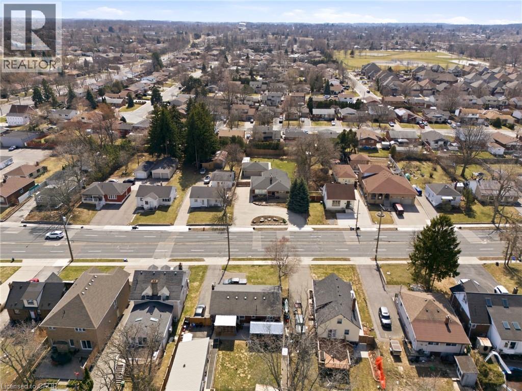 Aerial view of property and surrounding area with nearby suburban area - 473 Mohawk Road W, Hamilton, ON