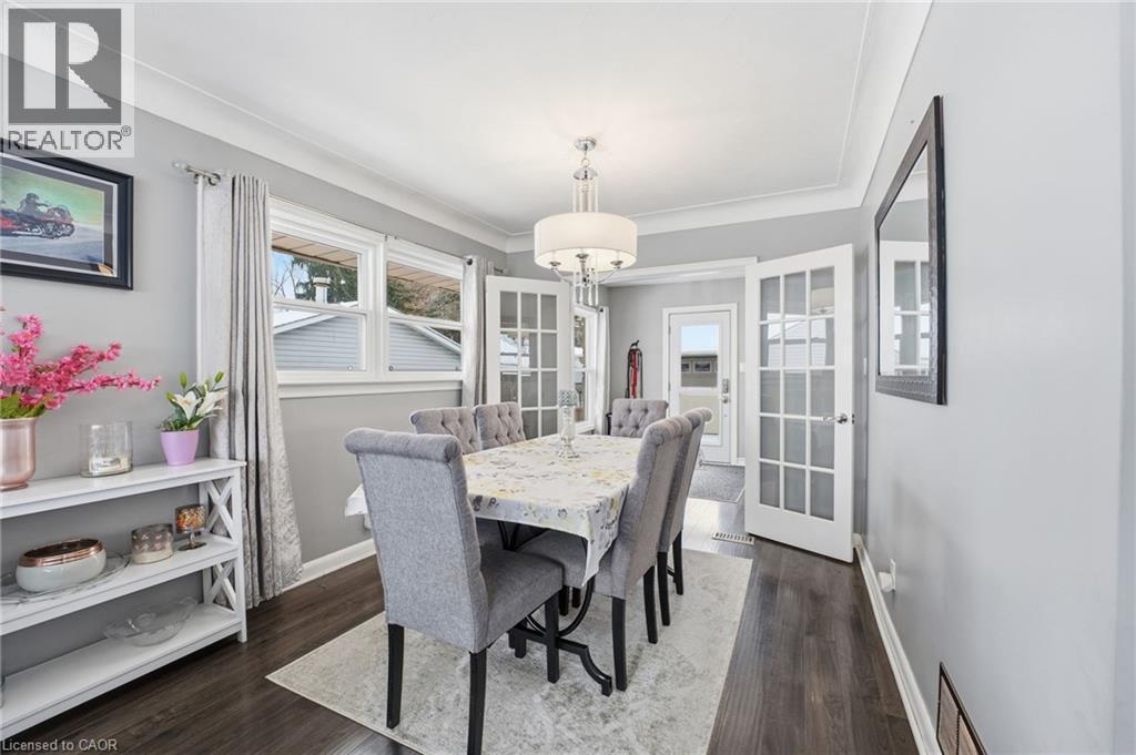 Dining area featuring dark wood finished floors and ornamental molding - 473 Mohawk Road W, Hamilton, ON