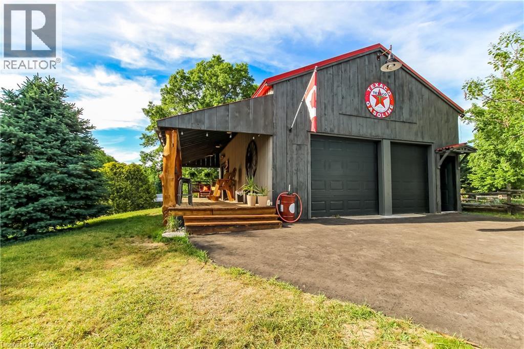 20 x 30 detached heated garage with car lift - 657 Windham Road 14 Road, Simcoe, ON - Outdoor With Deck Patio Veranda
