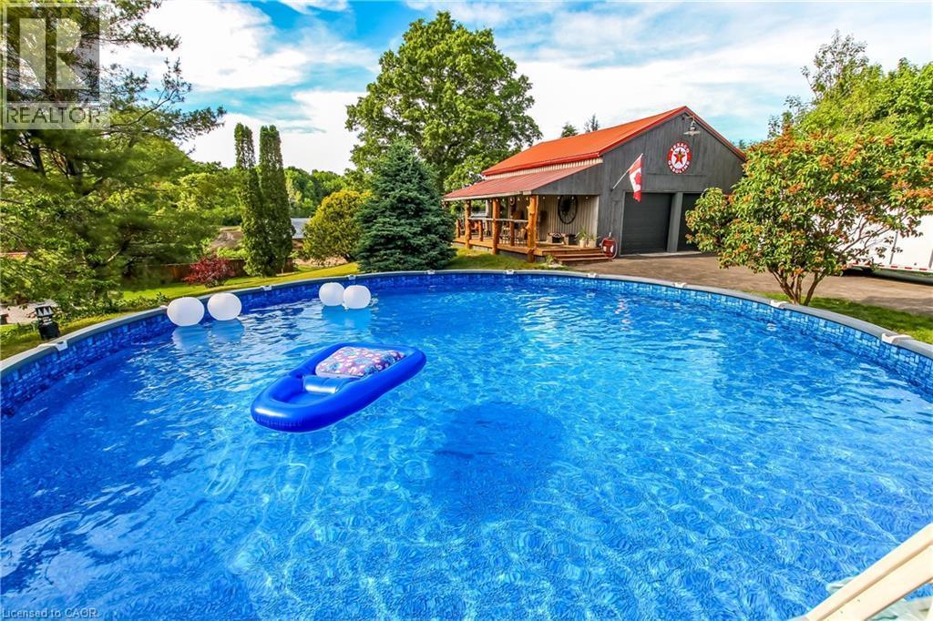 657 Windham Road 14 Road, Simcoe, ON - Outdoor With Above Ground Pool With Backyard