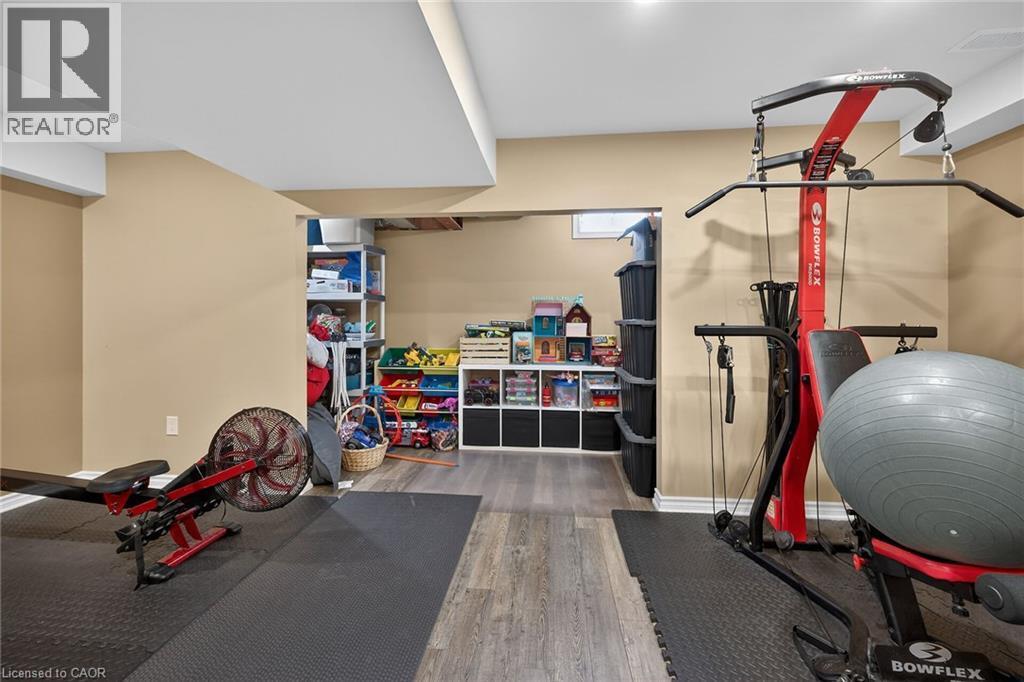 Finished basement space featuring recessed lighting, neutral wall paint, and wood-finish flooring - 149 Kinsman Drive, Binbrook, ON