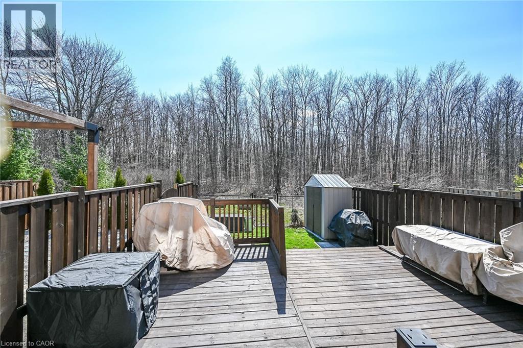 Expansive wood deck with a privacy fence, overlooking a wooded backdrop - 149 Kinsman Drive, Binbrook, ON