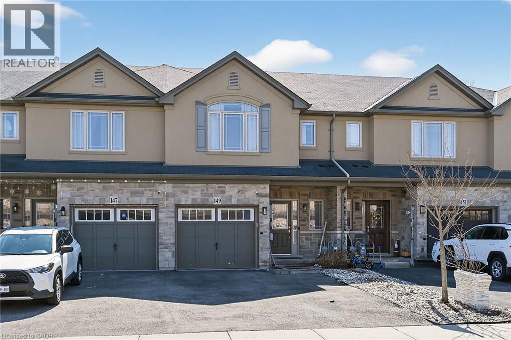 Townhouse exterior featuring a stone and stucco facade - 149 Kinsman Drive, Binbrook, ON