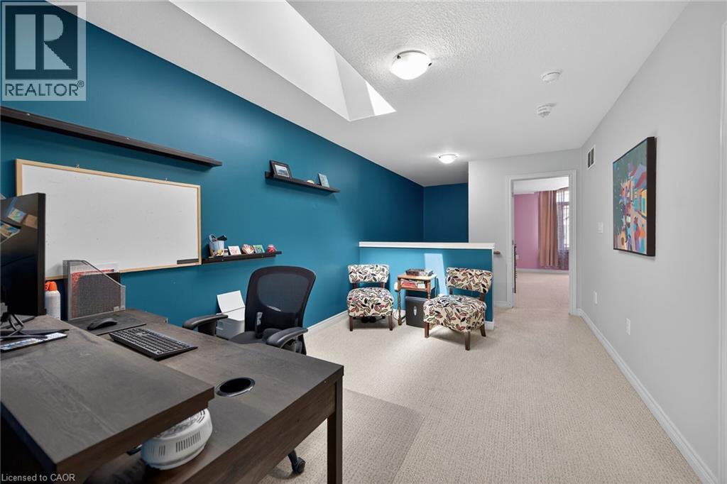 Bright open-concept area featuring a skylight, recessed lighting, and wall-mounted shelving - 149 Kinsman Drive, Binbrook, ON