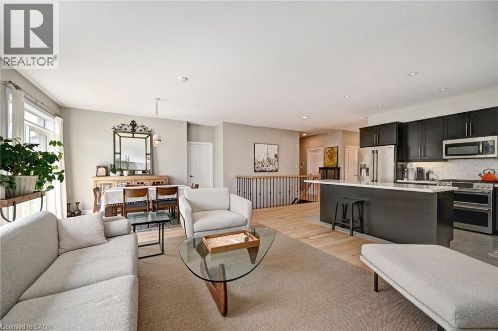 Open-concept living area featuring light-toned walls and recessed lighting - 219 Falconridge Drive, Kitchener, ON - Indoor Photo Showing Living Room