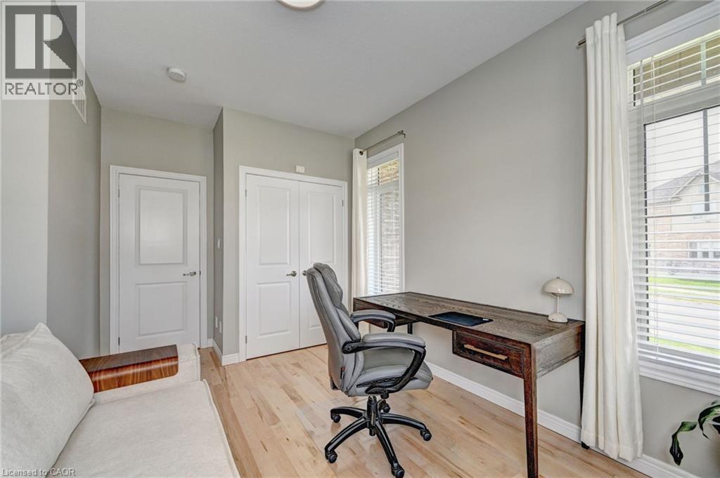 Light wood-finish flooring complements the neutral wall tones - 219 Falconridge Drive, Kitchener, ON - Indoor Photo Showing Office