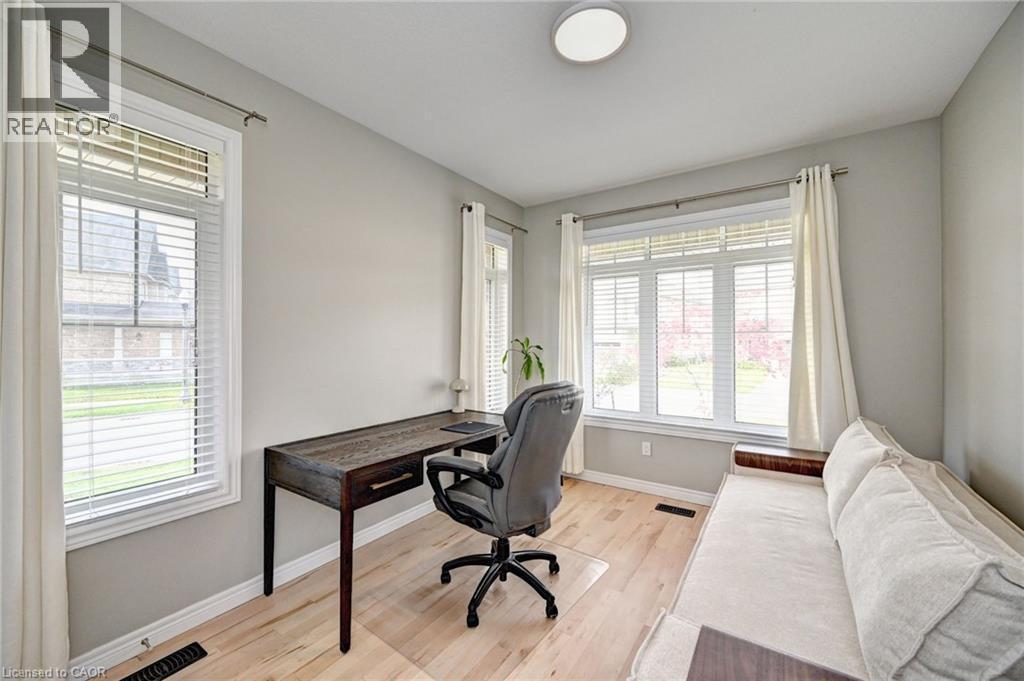 Bright room featuring light wood-finish flooring, neutral wall tones, and white trim - 219 Falconridge Drive, Kitchener, ON - Indoor