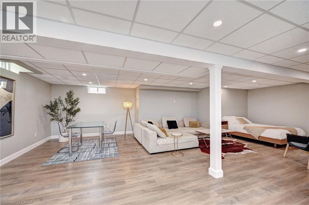 Spacious lower-level area featuring recessed lighting, light wood-finish flooring, and white baseboards - 219 Falconridge Drive, Kitchener, ON - Indoor Photo Showing Other Room