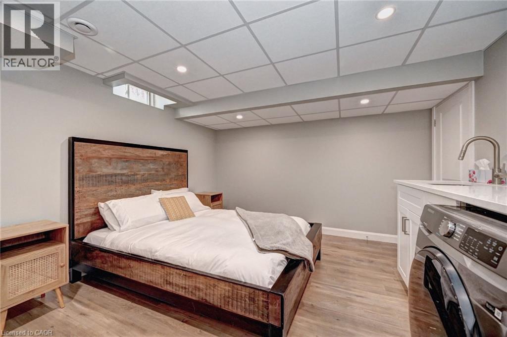 Spacious room featuring wood-finish flooring, recessed lighting, and a drop ceiling - 219 Falconridge Drive, Kitchener, ON - Indoor Photo Showing Bedroom