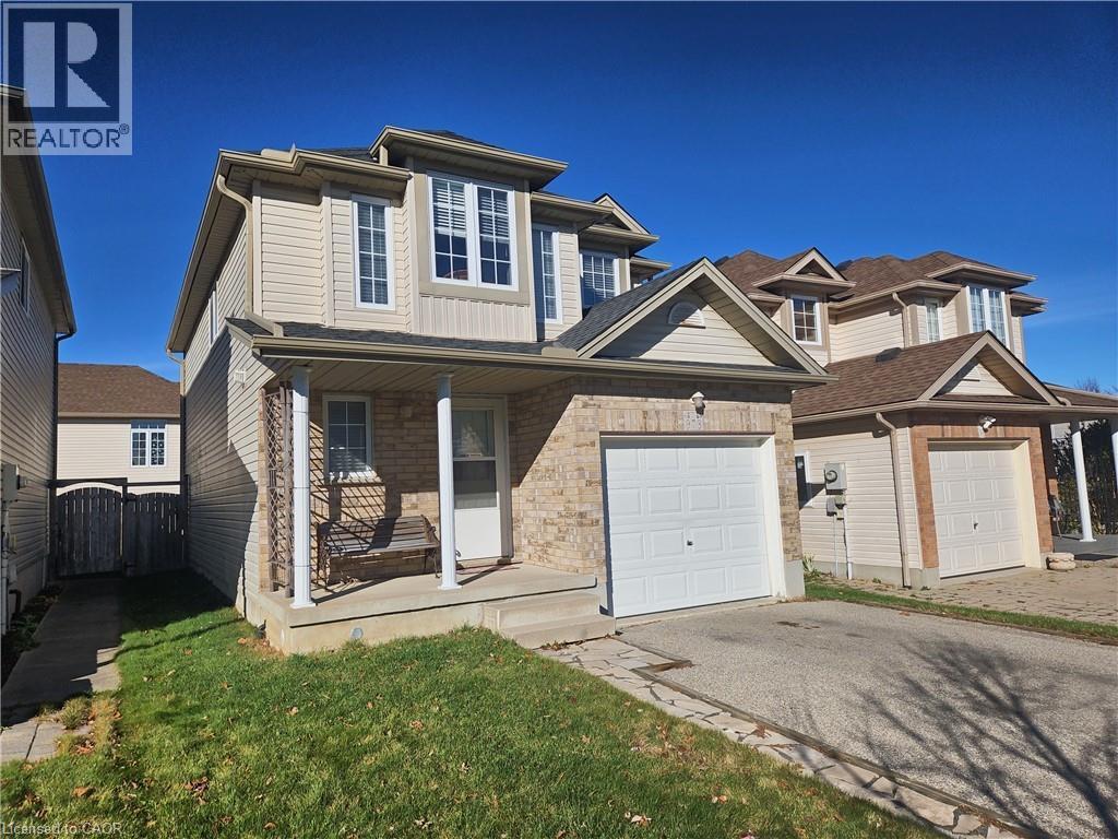 View of front facade featuring a garage and a porch - 973 Atlantic Boulevard, Waterloo, ON - Outdoor With Facade