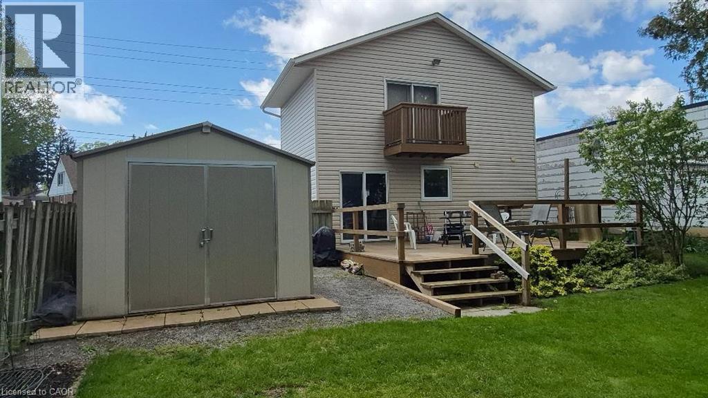 Rear exterior featuring a storage shed, wood deck and second-story balcony. - 257 Cedar Street, Simcoe, ON - Outdoor With Exterior