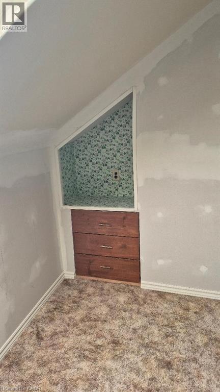Built-in wood-finish cubby with three drawers and polished chrome hardware. - 257 Cedar Street, Simcoe, ON - Indoor Photo Showing Other Room