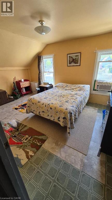 Second bedroom with sloped ceilings and two windows - 257 Cedar Street, Simcoe, ON - Indoor Photo Showing Bedroom