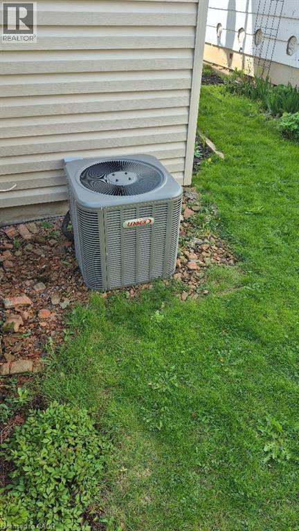 Lennox air conditioning unit situated alongside vinyl siding - 257 Cedar Street, Simcoe, ON - Outdoor