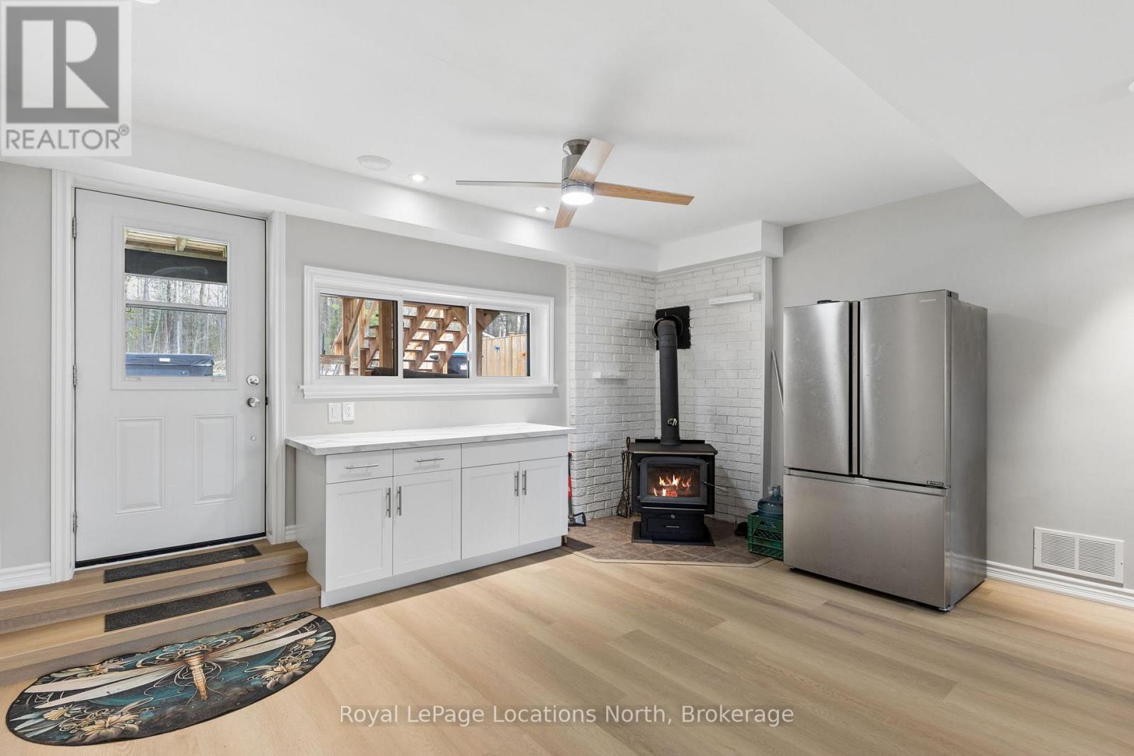 93 Ronald Avenue, Tiny, ON - Indoor Photo Showing Other Room With Fireplace