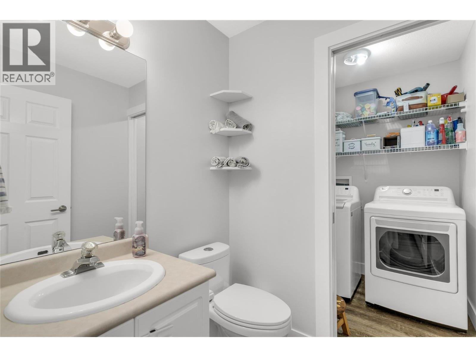 convenient half bath by the garage - 3819 Glen Canyon Drive, West Kelowna, BC - Indoor Photo Showing Laundry Room